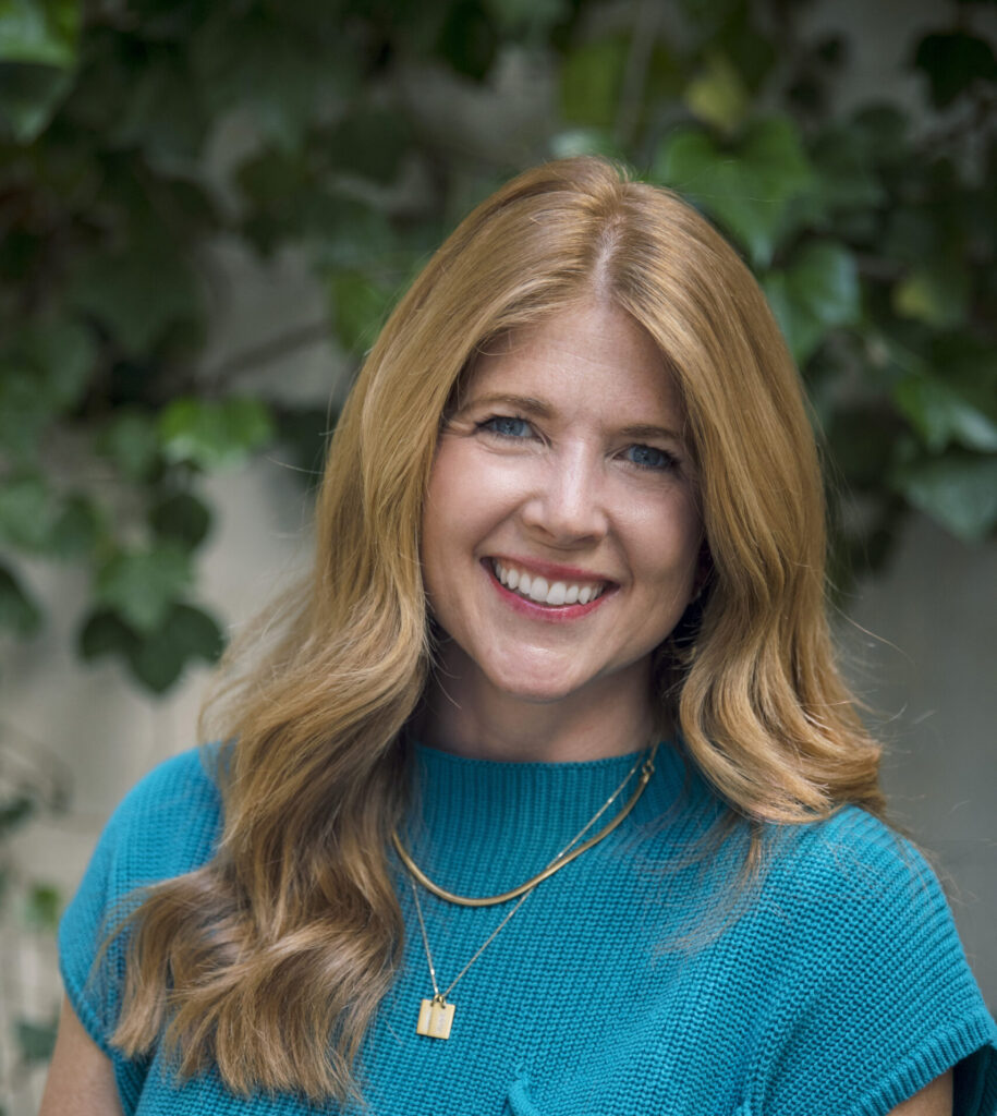 Jen Naecker, nonprofit consultant and co-founder of the Good Work Group, smiling in a warm outdoor setting.